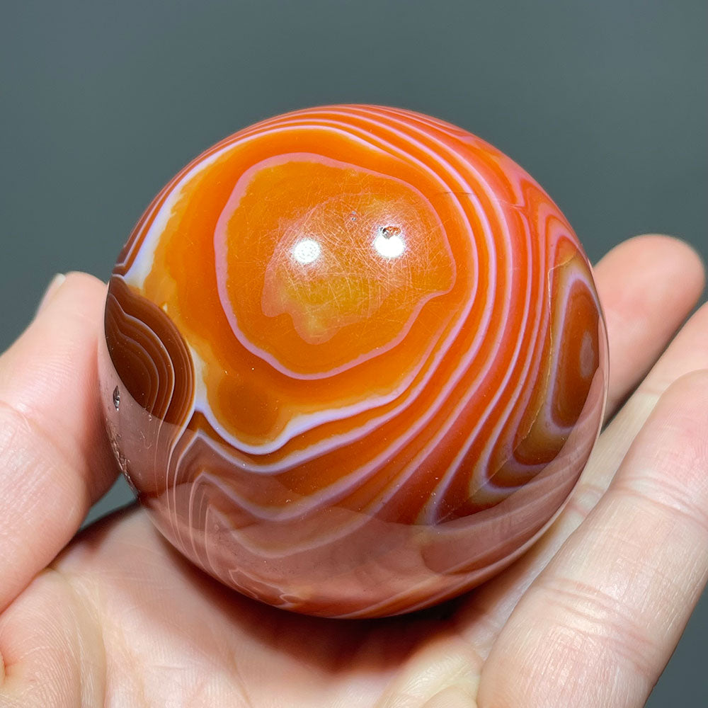Vibrant Banded Carnelian Sphere with Stunning "Eye" Formation