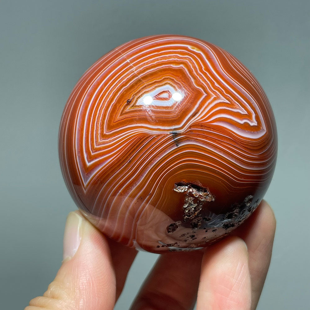 Vibrant Banded Carnelian Sphere with Stunning "Eye" Formation