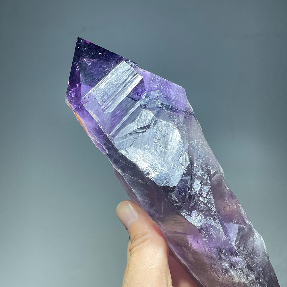 Side view of a large amethyst scepter showing the natural crystal faces and record keeper etchings