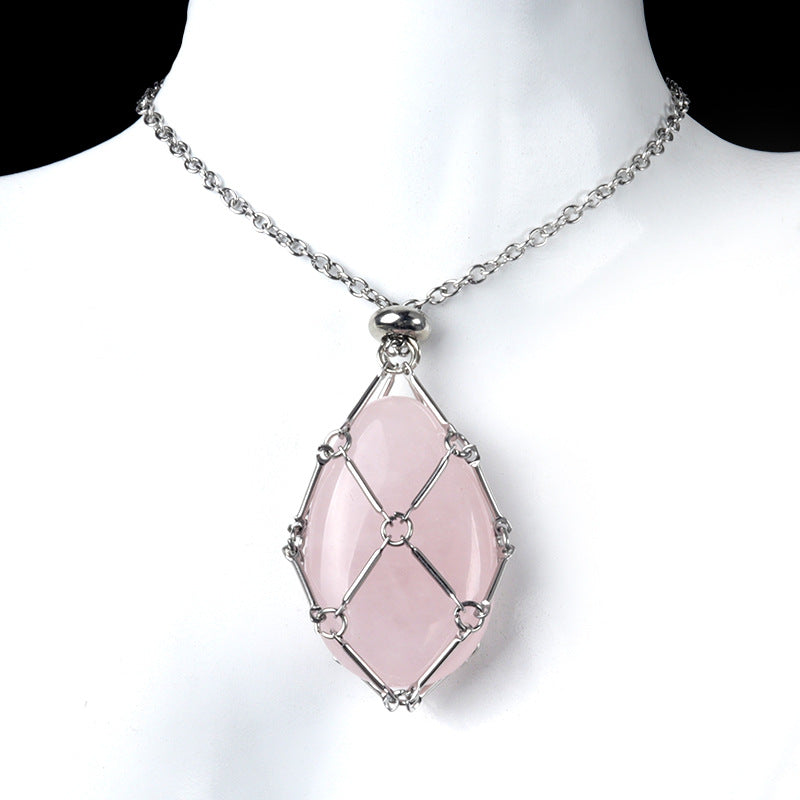 A rose quartz crystal egg pendant necklace on a white display bust.