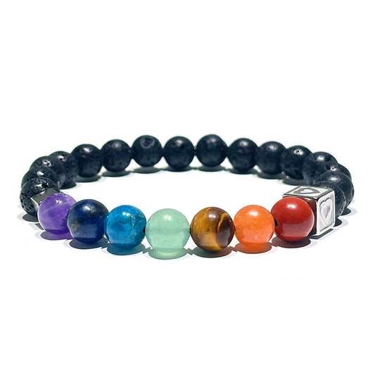A 7 chakra bracelet with colorful gemstone beads and black porous lava stone on a stretch cord