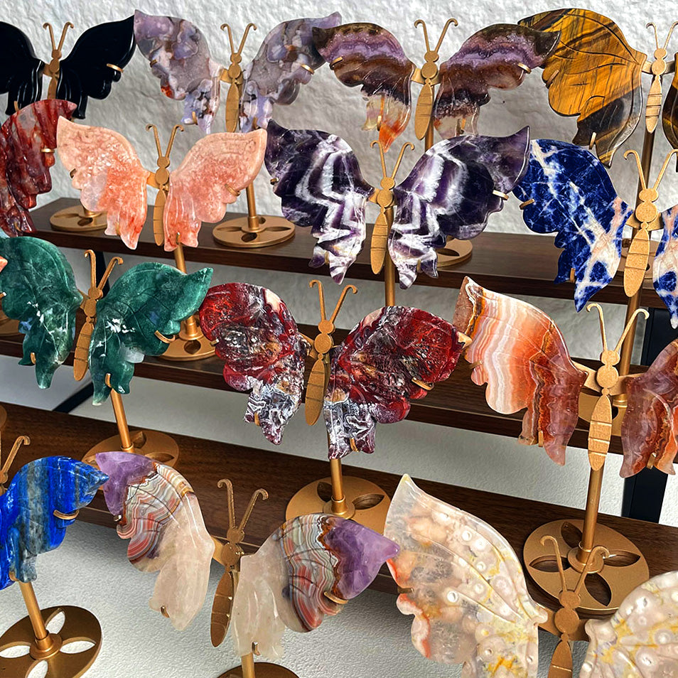 Premium hand-carved natural crystal butterflies on gold stands - Collection of Tiger's Eye, Amethyst, and Moss Agate specimens.
