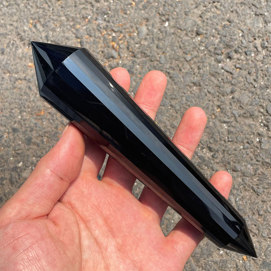 Large 24-sided black obsidian Vogel wand held in a hand.