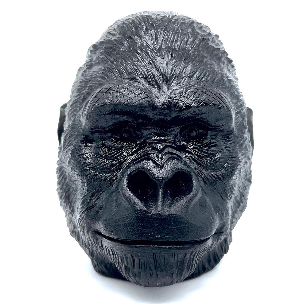 Front-facing view of a powerful black obsidian gorilla head carving on a white background.