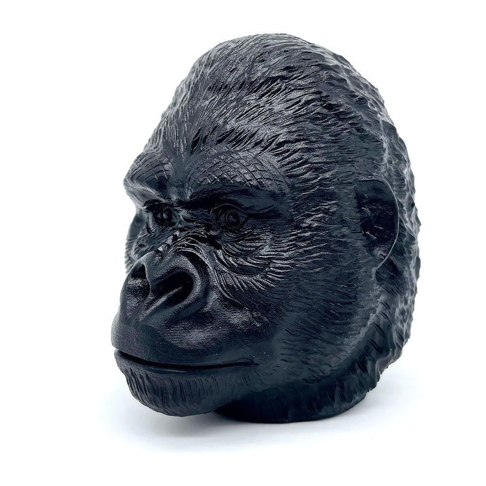 Three-quarter view of a detailed black obsidian gorilla head sculpture.