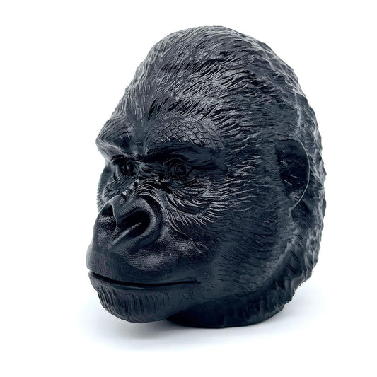 Three-quarter view of a detailed black obsidian gorilla head sculpture.