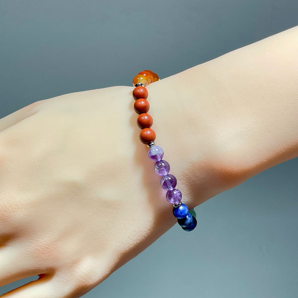 A person wearing the colorful 7 chakra stretch bracelet on their wrist