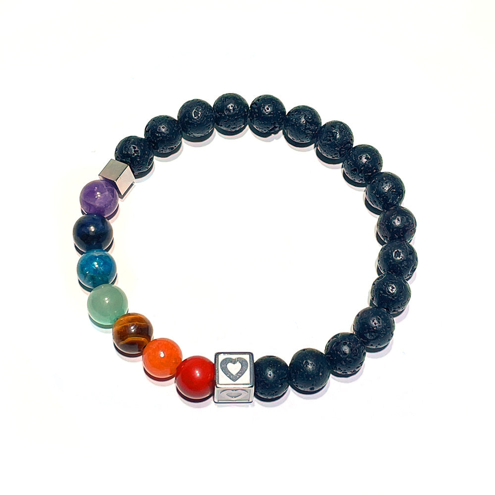 A close-up of the 7 chakra lava stone bracelet showing the stainless steel heart cube detail.
