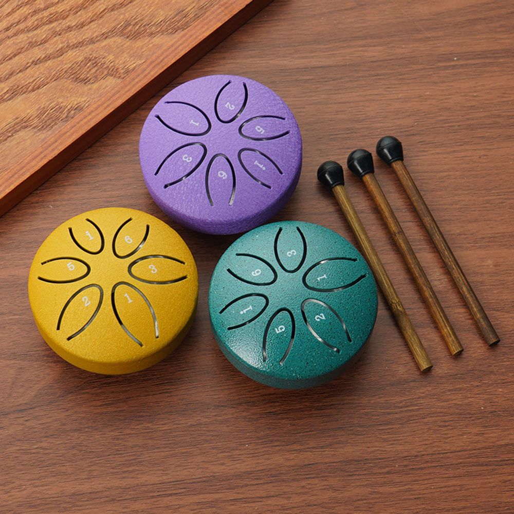 Three colorful mini ethereal drums in purple, yellow, and green with their wooden mallets