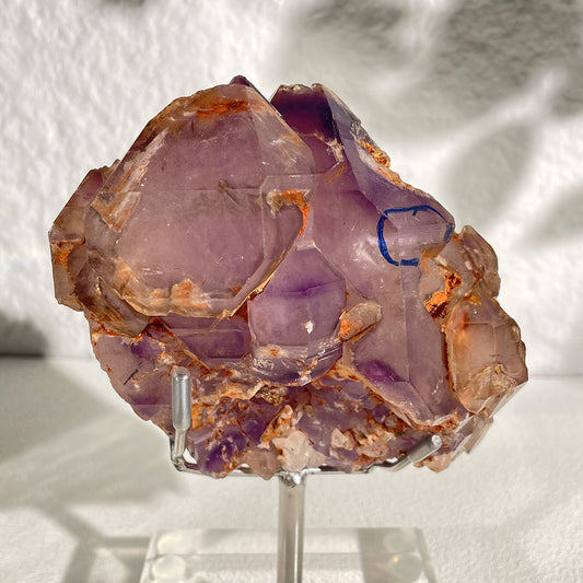A massive 1.45kg raw natural Madagascar Amethyst Elestial quartz cluster featuring complex skeletal growth, resting on a clear acrylic display stand.