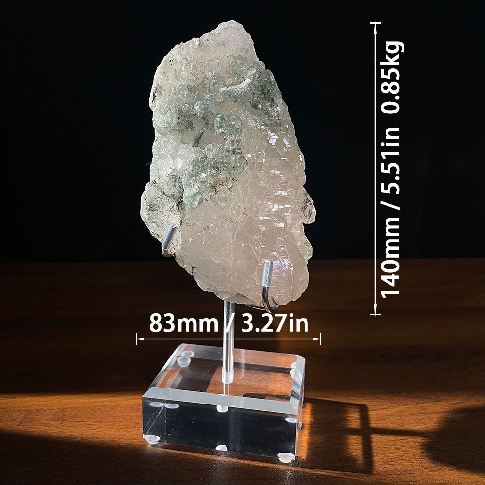 Exact piece of a raw Himalayan elestial quartz crystal with green chlorite phantom inclusions, displayed on a clear acrylic stand.