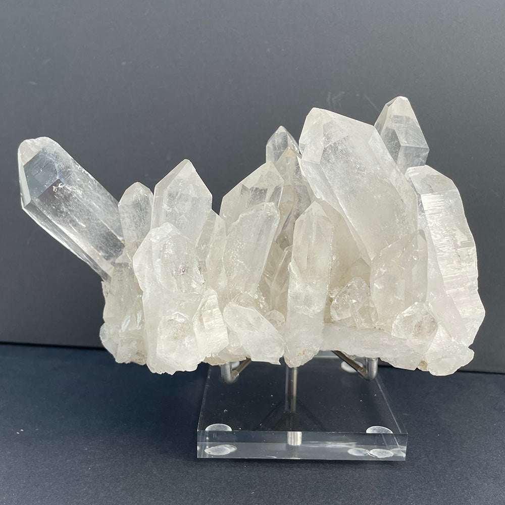 Large 1.22kg natural Himalayan quartz cluster on a stand showing multiple clear crystal points