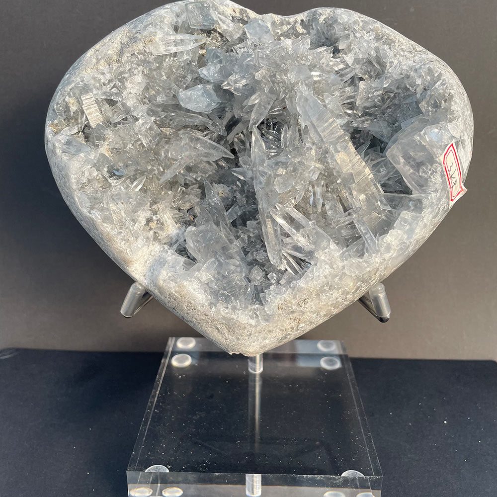 Large 3kg natural blue celestite crystal heart displayed on a clear acrylic stand.