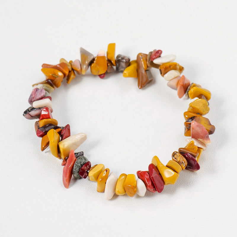 A colorful Mookaite Jasper crystal chip bracelet with yellow, red, and cream stones