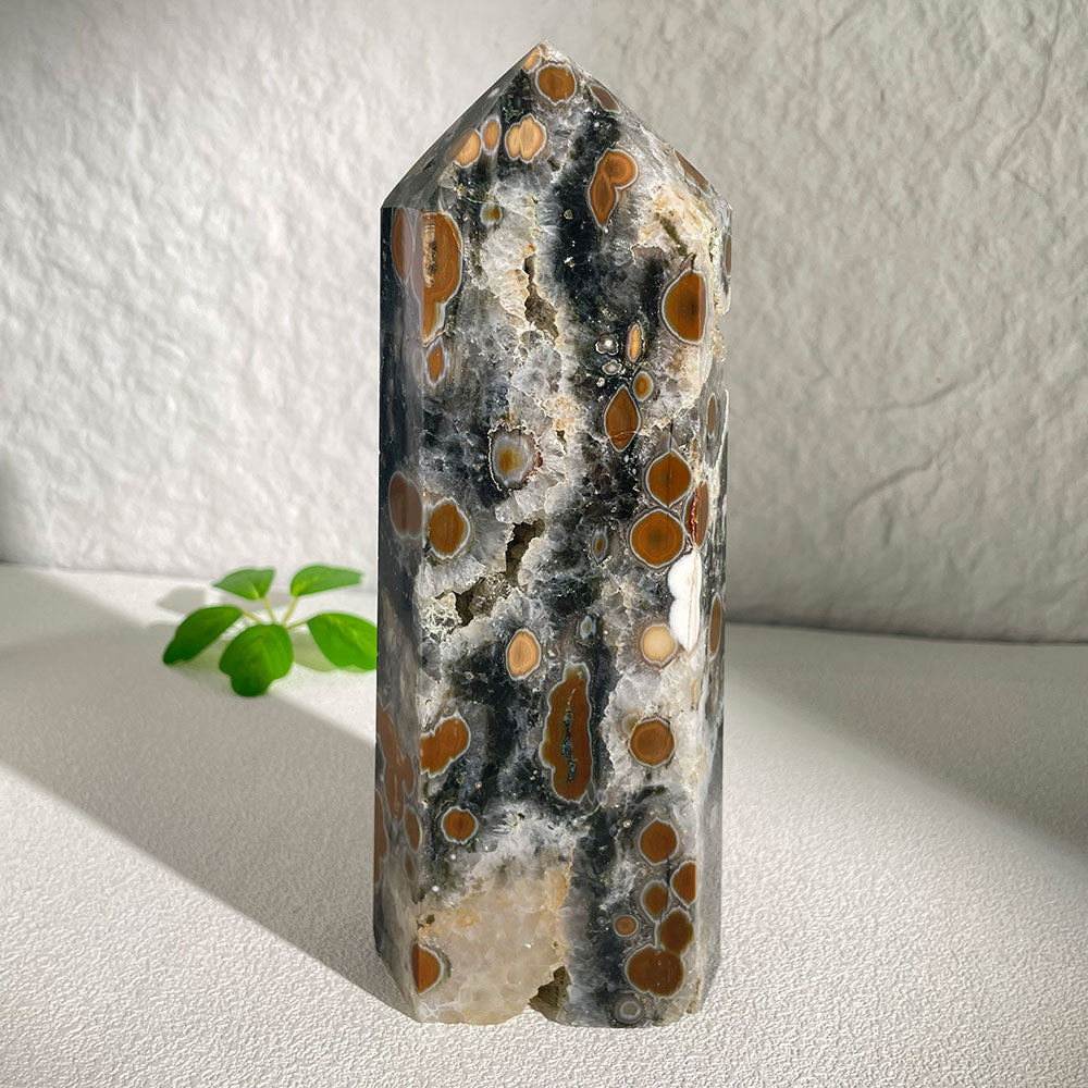 A massive 1.24kg polished natural Ocean Jasper crystal tower from Madagascar, featuring bold brown and white orbicular bullseye patterns on a dark matrix.