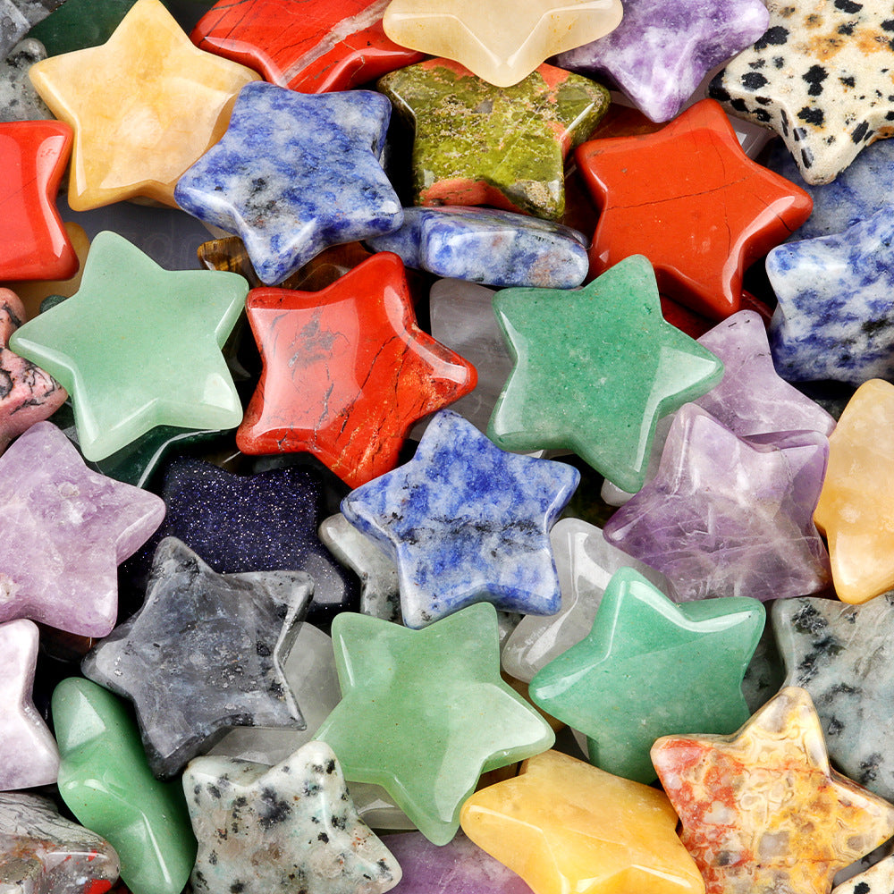 A close-up pile of colorful, polished gemstone stars, showing their variety and texture
