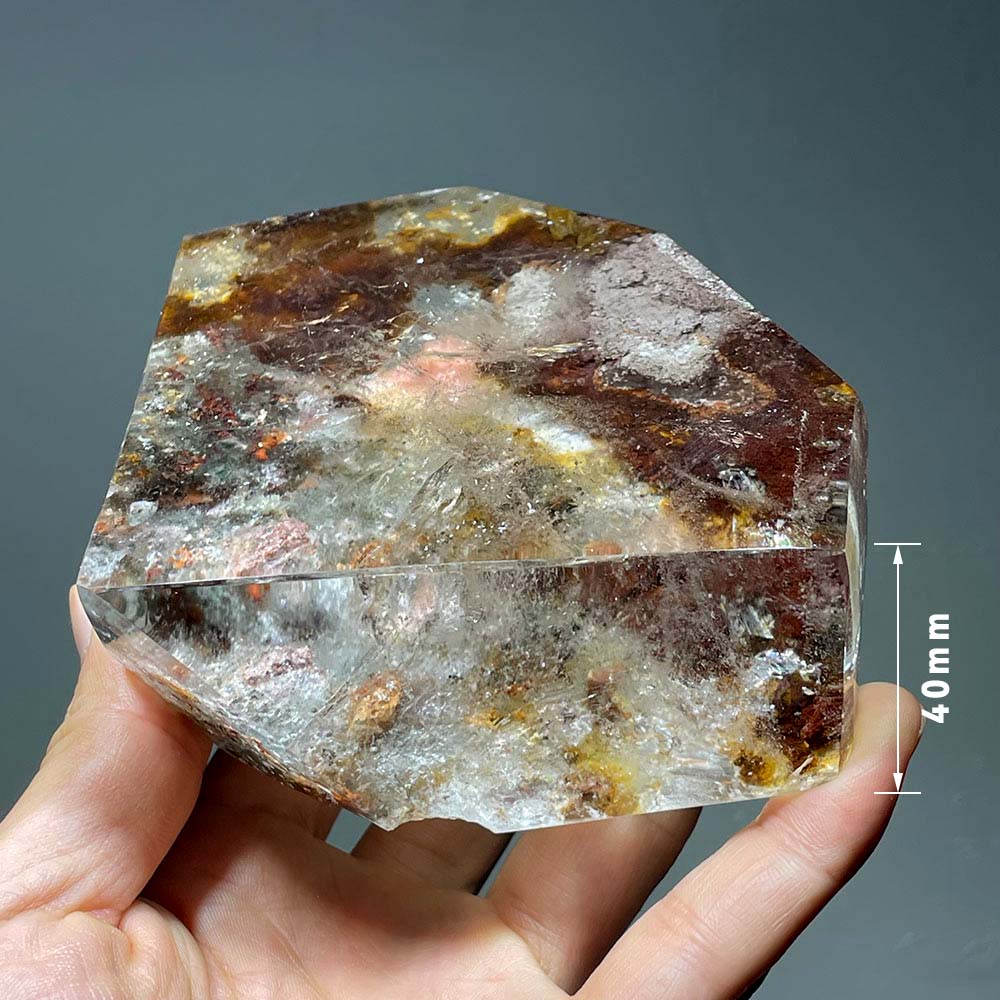 Side profile of a polished lodolite crystal slab, showing its thickness and internal landscape.