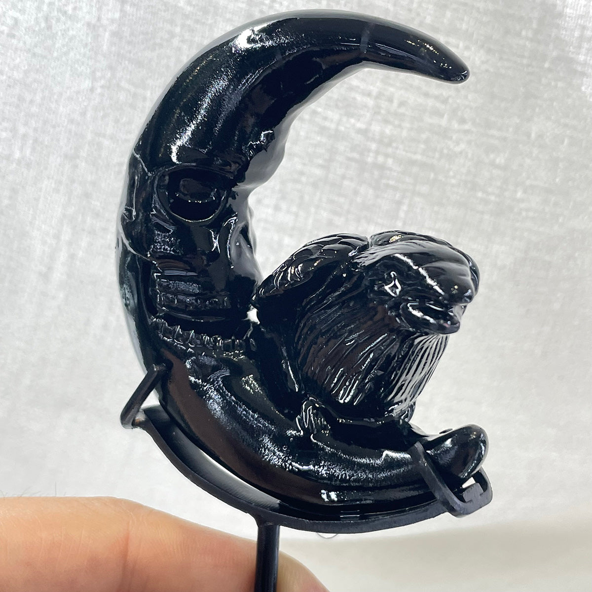 Black obsidian raven and skull moon statue shown from an angled view.