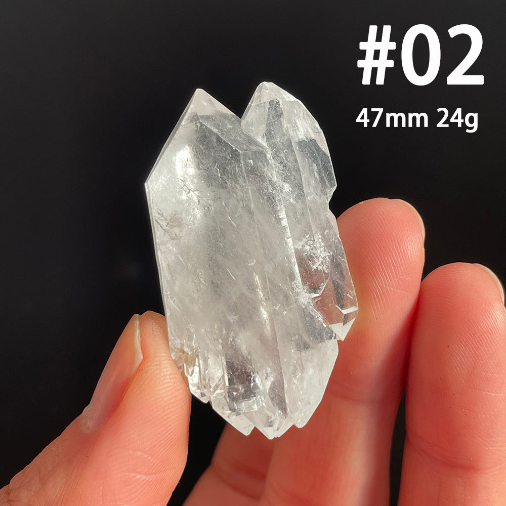 Close up of natural raw Faden Quartz crystal showing the distinct white thread line running through the center