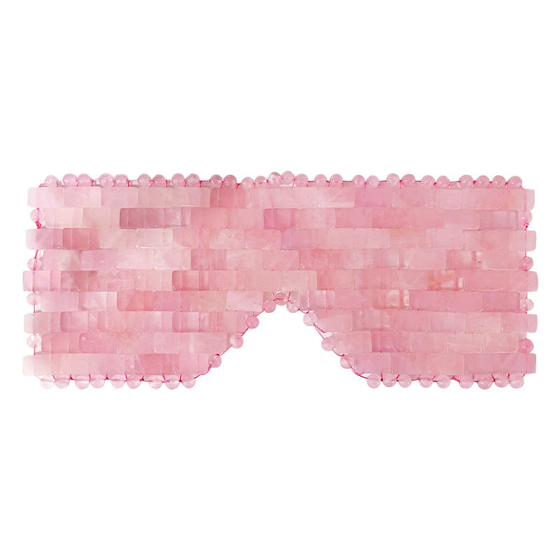 A light pink rose quartz eye mask for self-care and beauty rituals