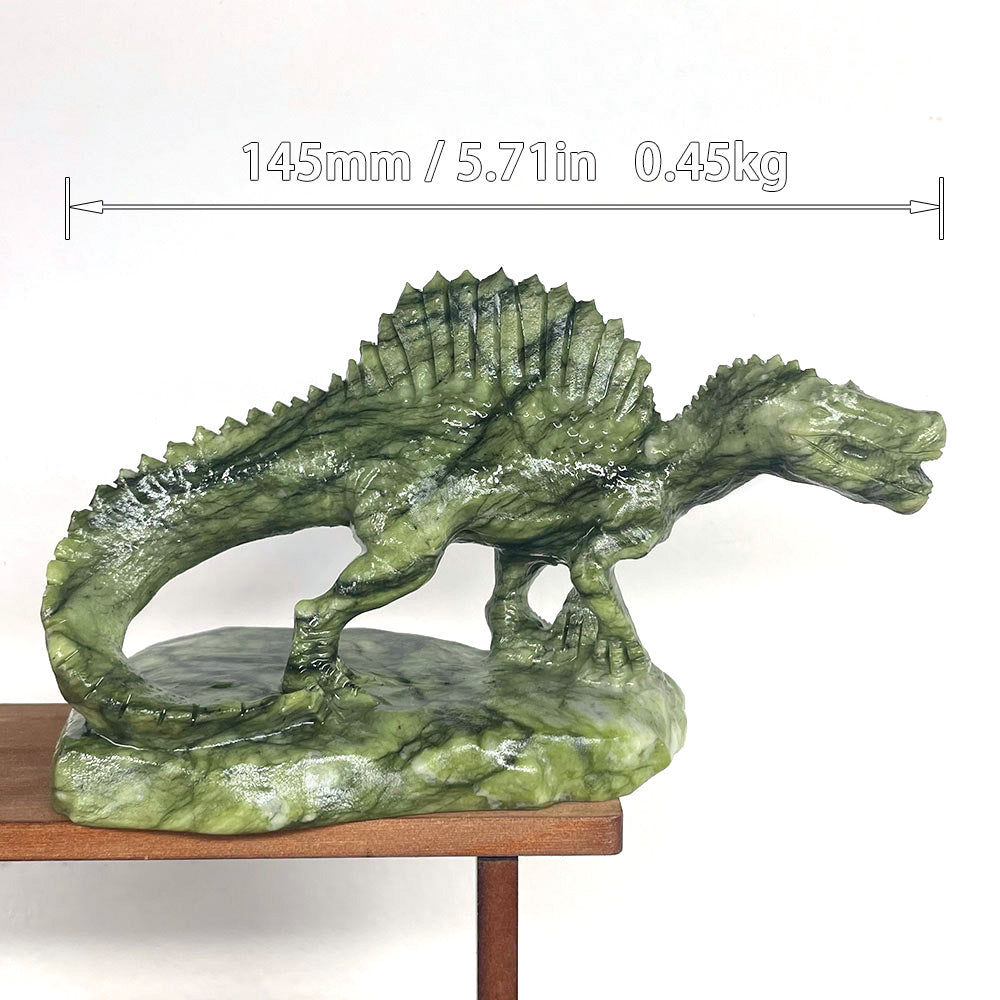 Top view of a carved crystal Spinosaurus held in hand, highlighting the ridges of the sail-back spine.