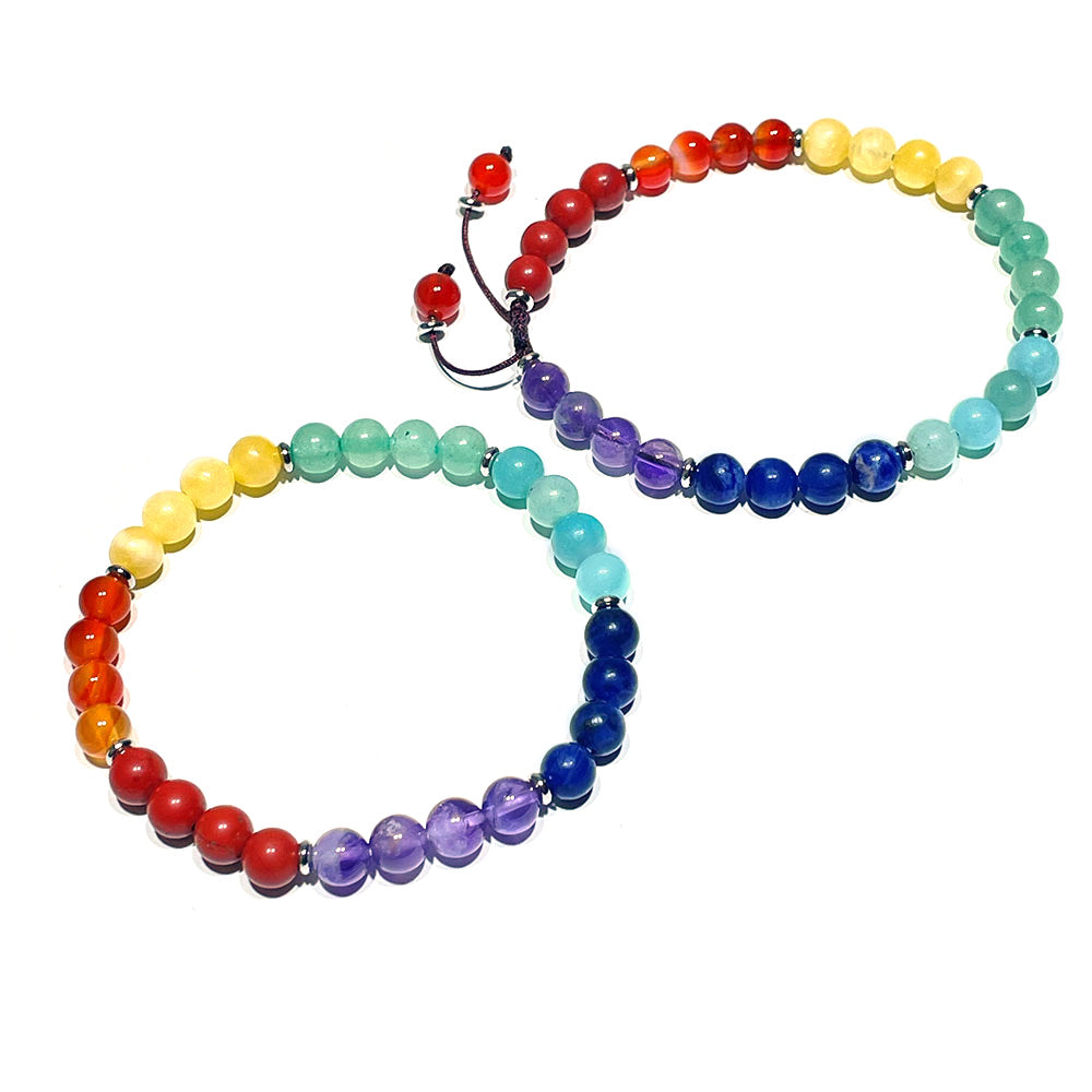 Two 7 chakra bracelets, one stretch style and one adjustable style, on a white background
