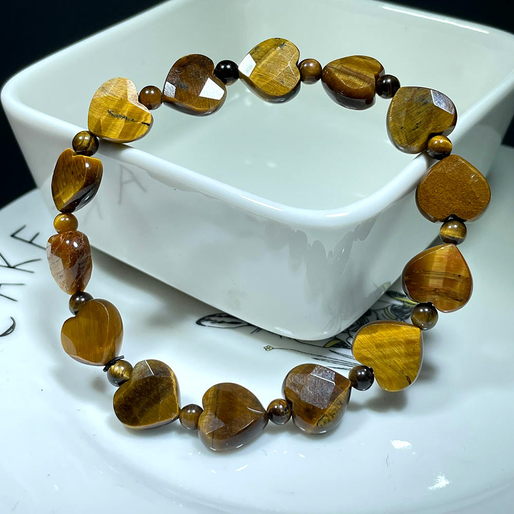 A golden-brown Tiger's Eye bracelet with sparkling faceted heart beads on display