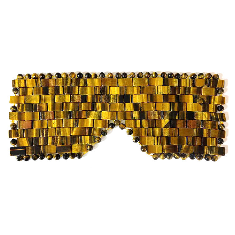 A golden-brown tiger's eye gemstone eye mask with a woven pattern