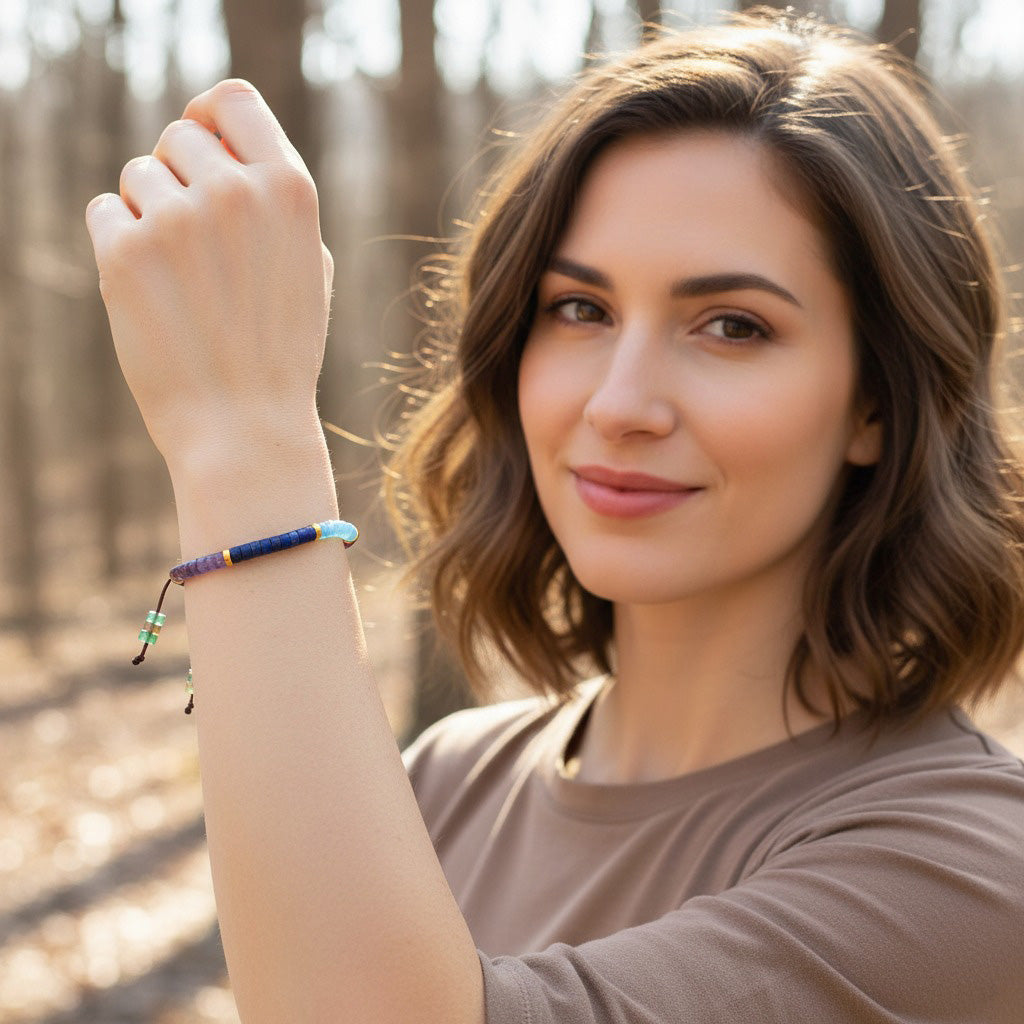 A smiling woman outdoors wearing the 7 chakra healing bracelet on her wrist