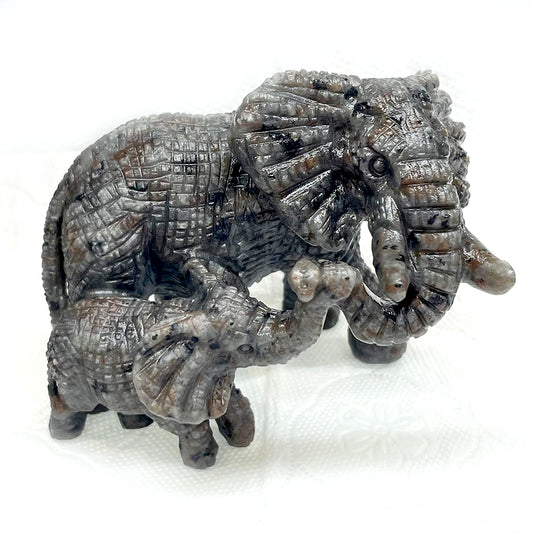A detailed, hand-carved Yooperlite statue of a mother elephant and her calf